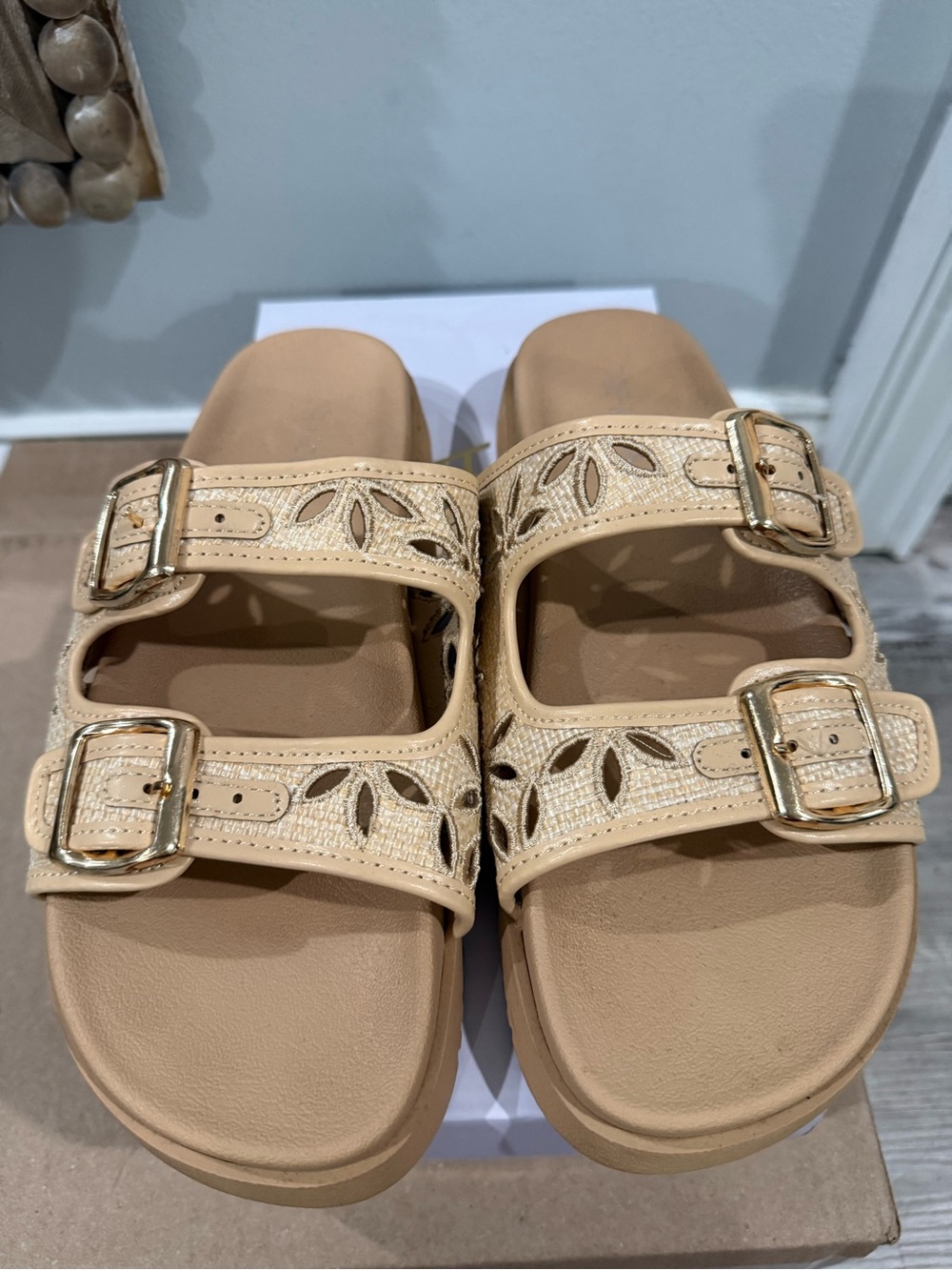 Top Moda beige and raffia double-buckle slide sandals featuring laser-cut floral